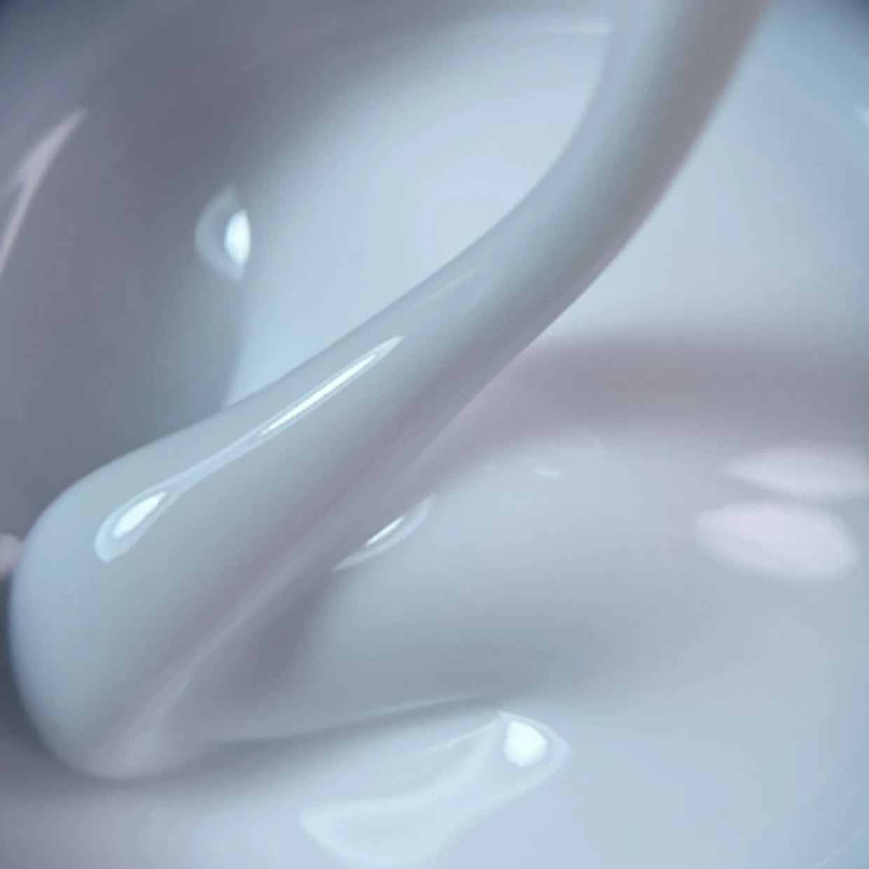 Close-up of thick white UV gel for nail extensions in a smooth, glossy texture