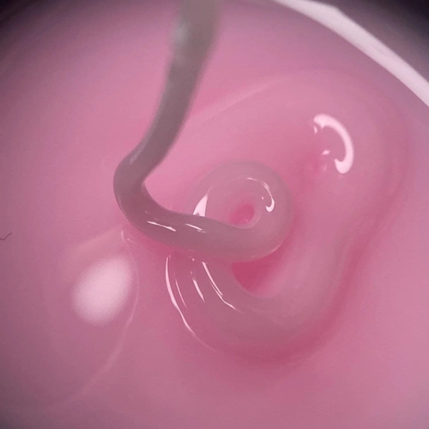 Close-up of pink UV gel for nails, thick texture suitable for professional manicure