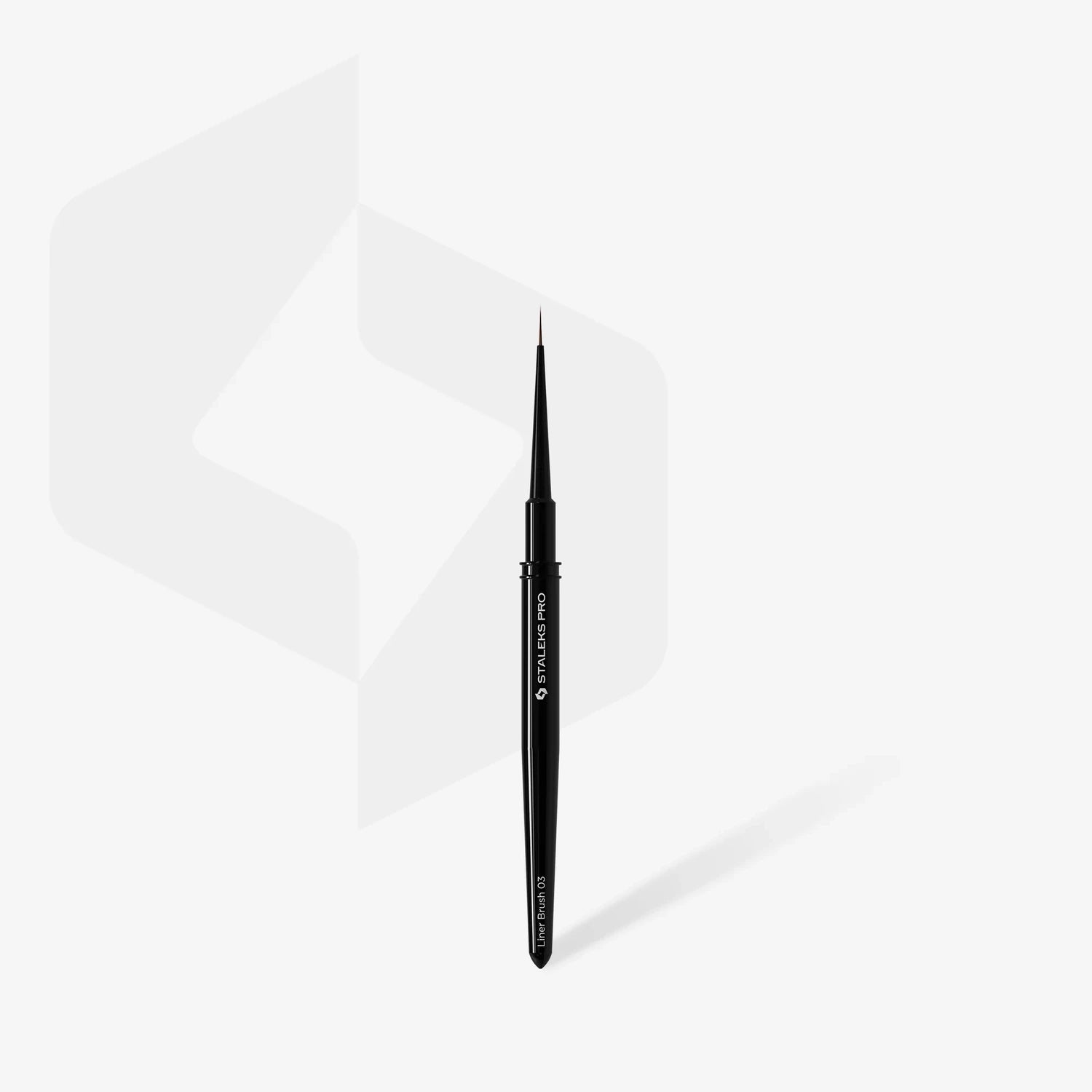 Fine-tipped nail art brush for detailed manicure on white background