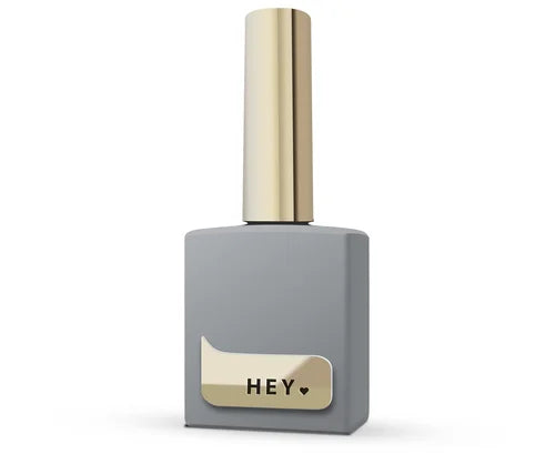 Gray nail polish bottle with gold cap and label on a white background