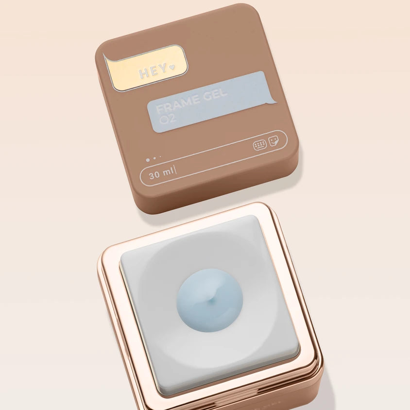 Square container of frame gel in neutral packaging, open to reveal light blue nail gel, 30ml