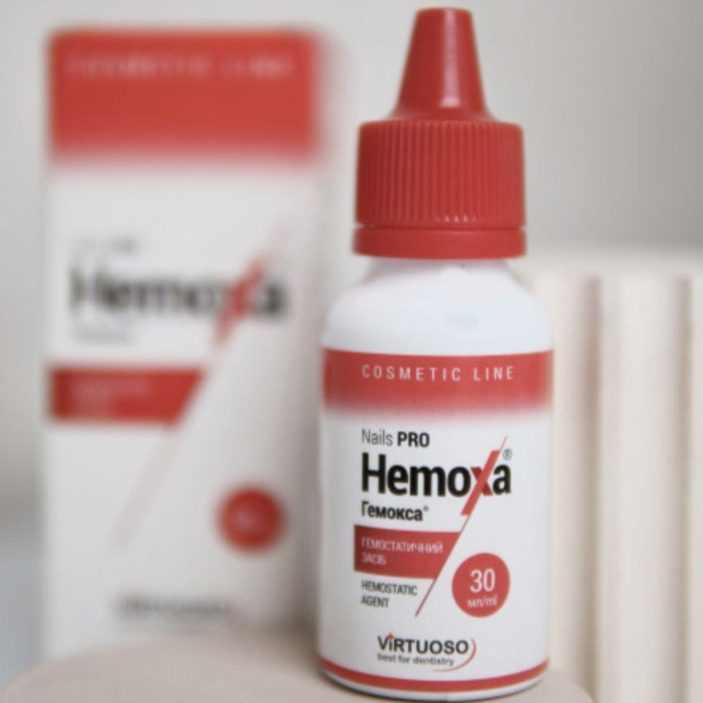Nail hemostatic agent bottle for manicure with red cap, product packaging in background
