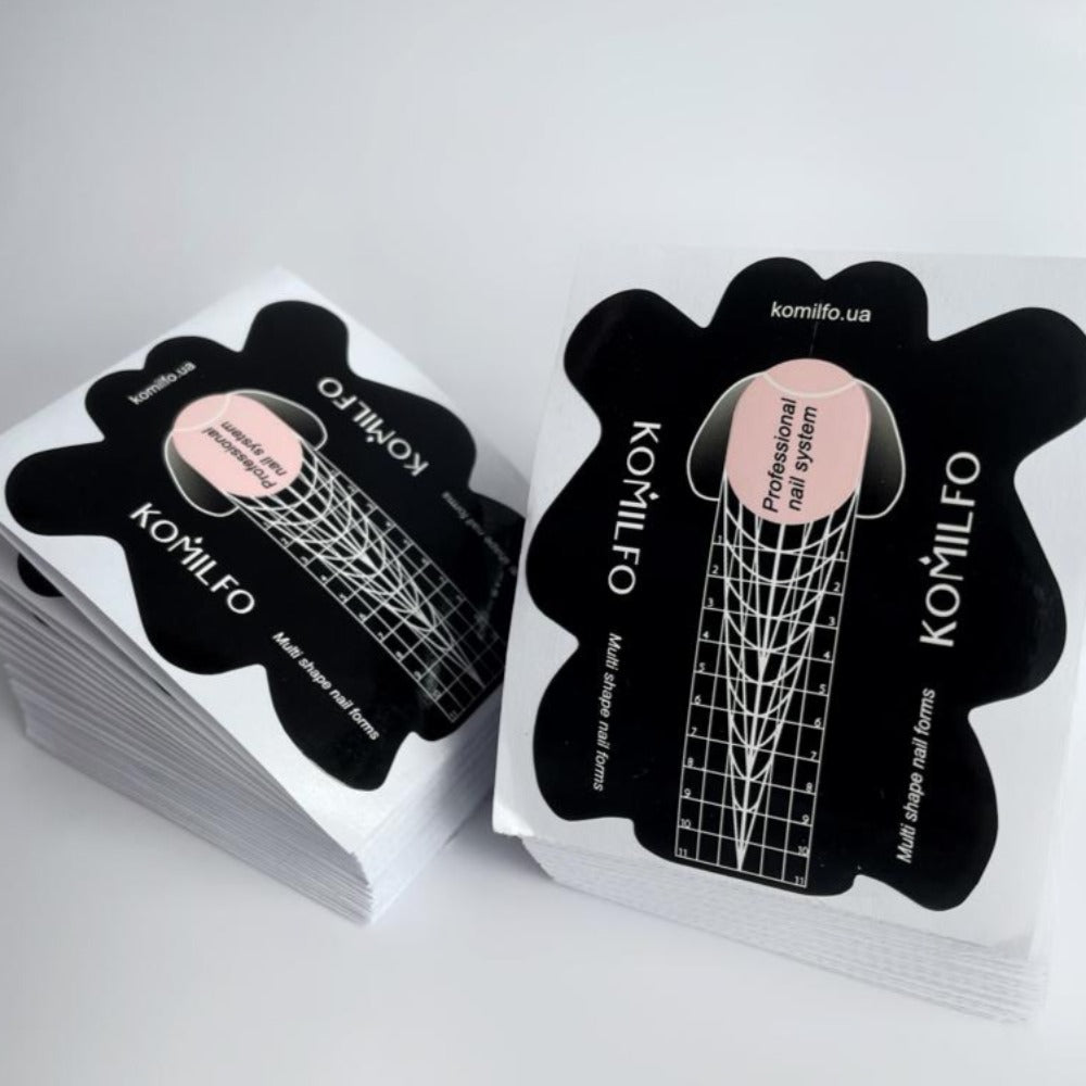 Stack of black and white multi shape nail extension forms for professional manicure