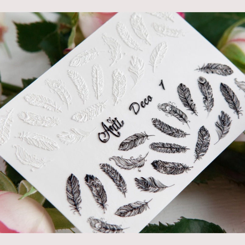Feather nail art stickers sheet with black and white feather designs, for manicures