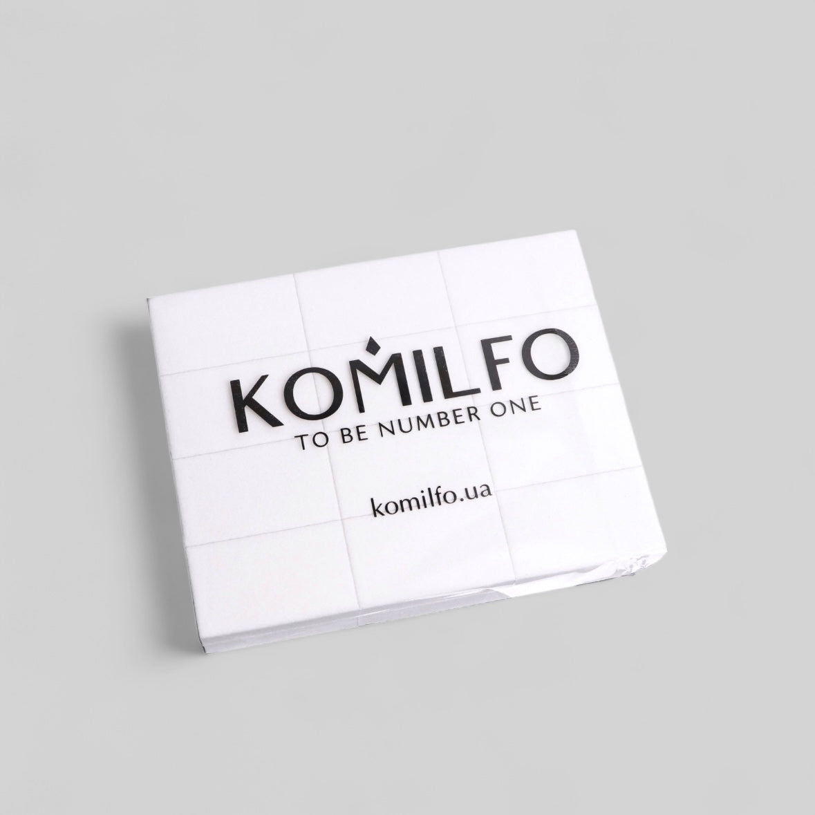 Komilfo nail product lint-free wipes on a light gray background