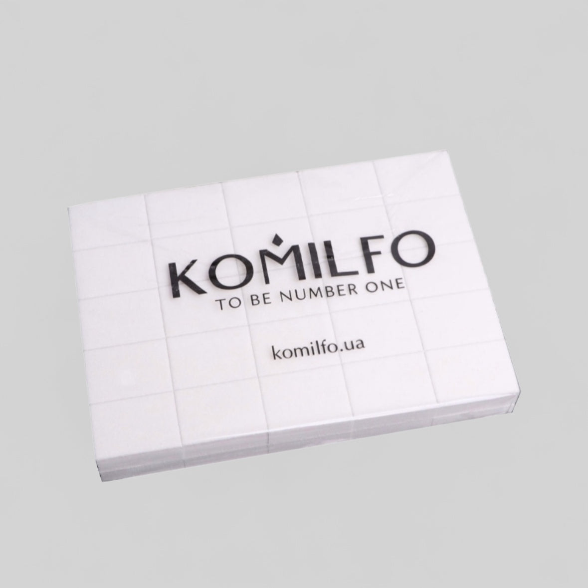 Komilfo lint-free nail wipes for manicure, white rectangular pads on grey background