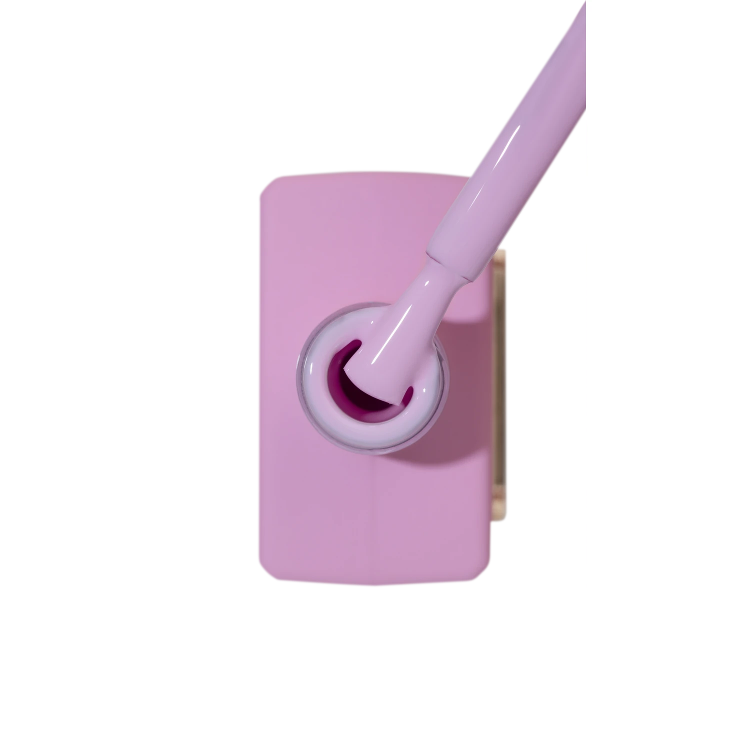 Open pink nail polish bottle with matching brush, professional manicure product