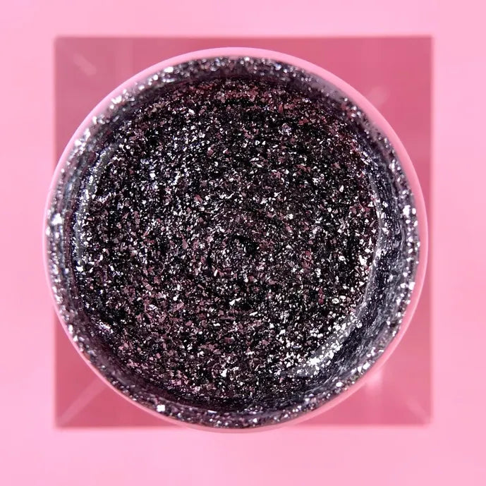 Black and silver glitter UV gel in jar for professional nail art on pink background