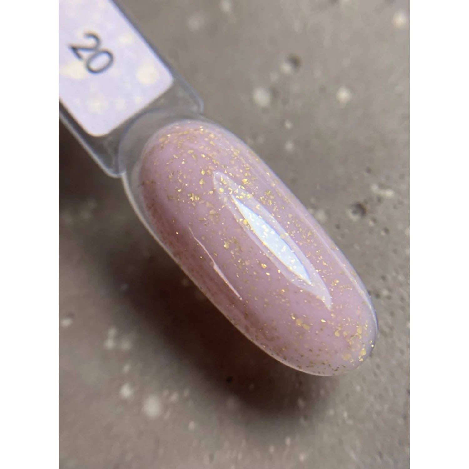 Swatch of pink UV gel nail polish with fine gold glitter, labeled shade 20