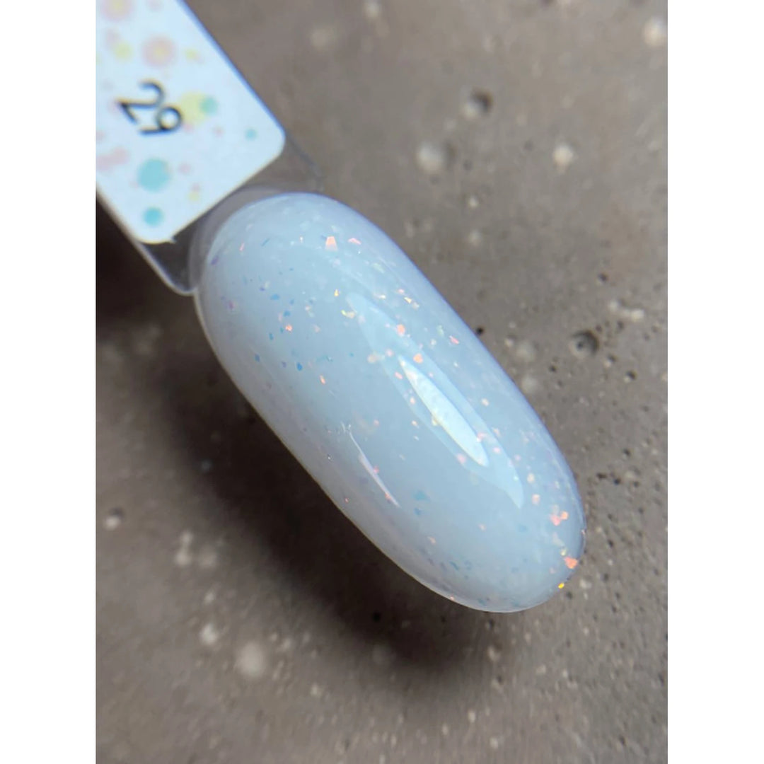 Swatch of pale blue UV gel nail polish with subtle glitter on a sample nail tip