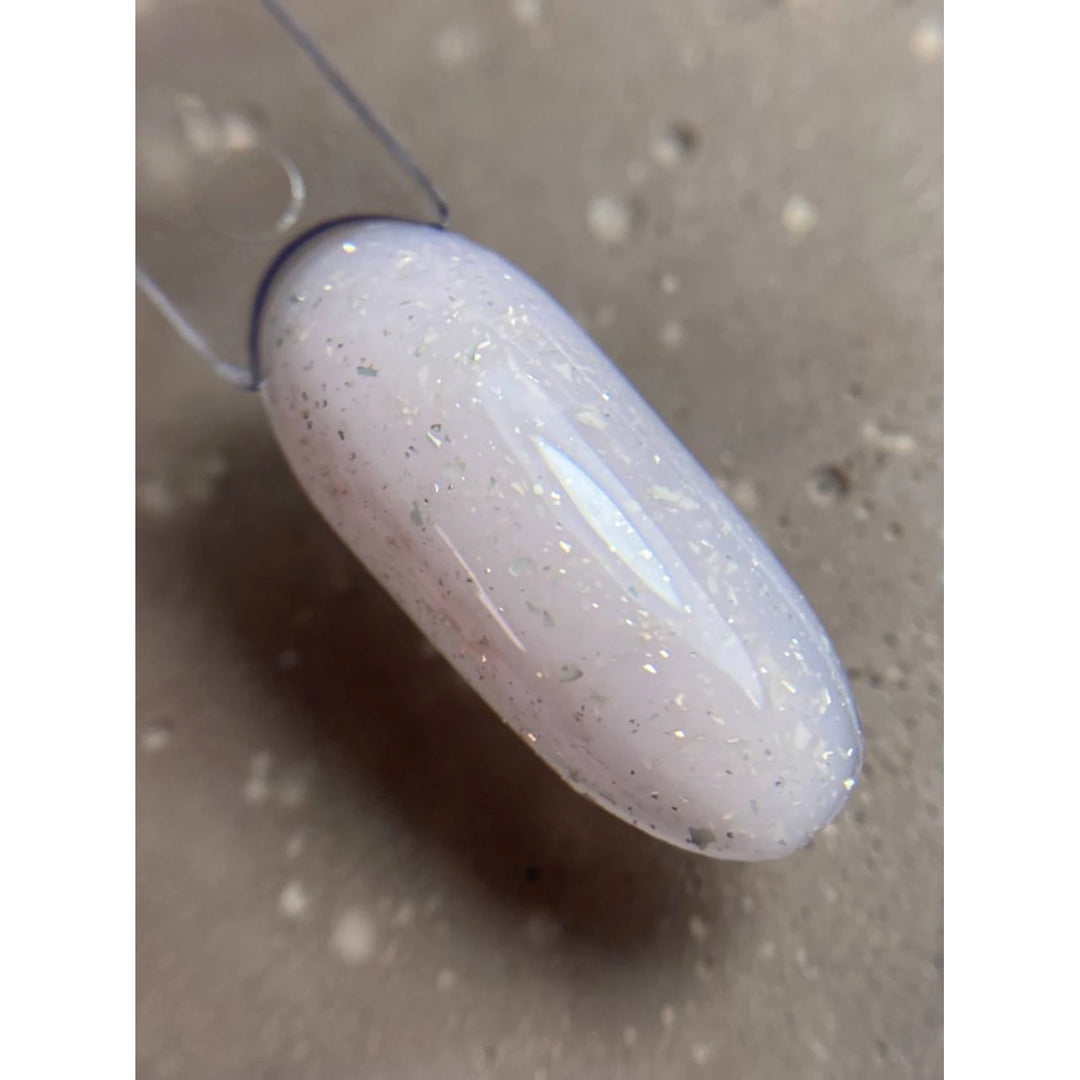 Swatch of semi-transparent milky white gel polish with fine silver glitter for nails