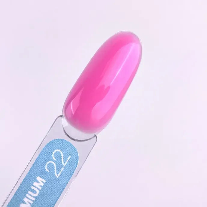 Swatch of glossy pink builder gel nail polish on a sample stick, labeled 22