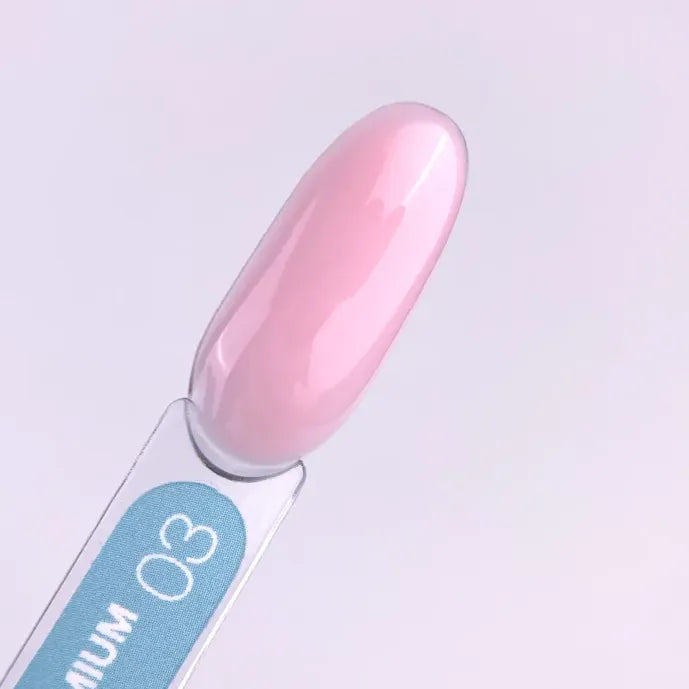 Sample swatch of glossy light pink builder gel for manicure, labeled with number 03.