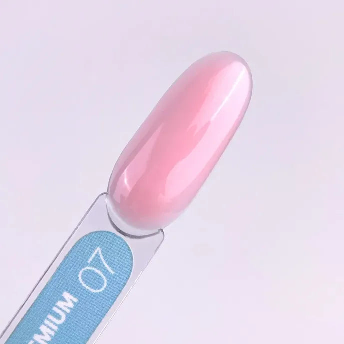 Swatch of glossy pink builder gel for nails on a clear display stick labeled 07.