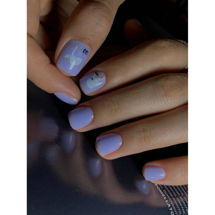 Lilac manicure with glossy finish and swan nail art design on short natural nails