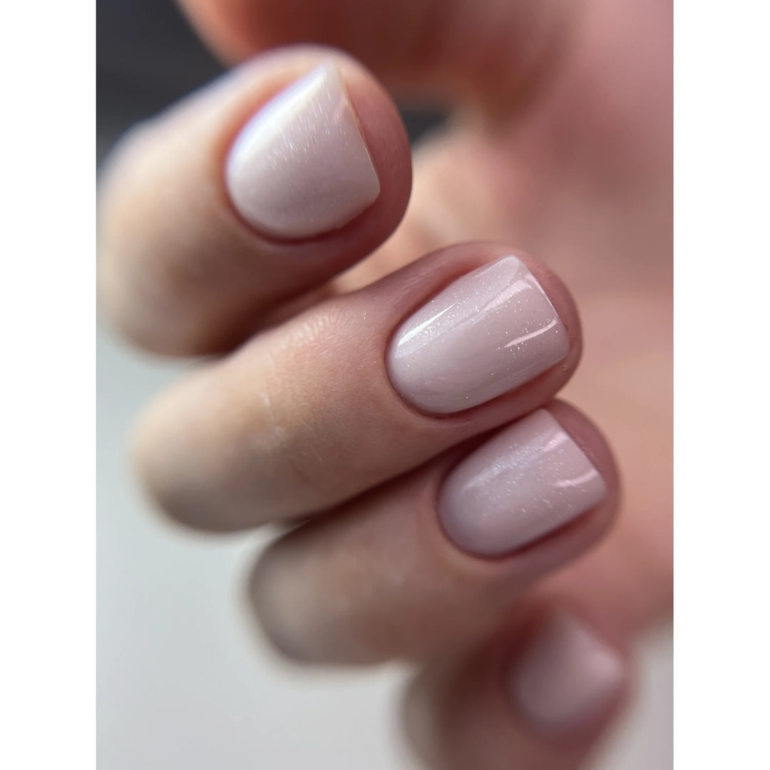 Short natural nails with glossy light pink UV gel polish manicure