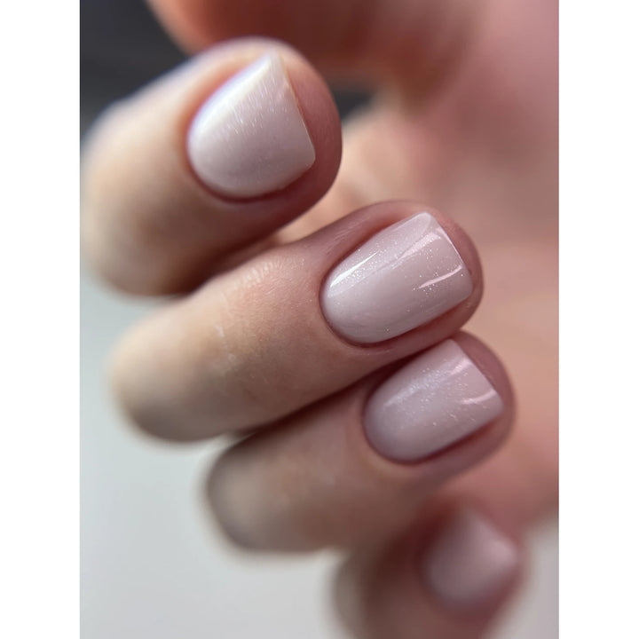 Short natural nails with glossy light pink UV gel polish manicure