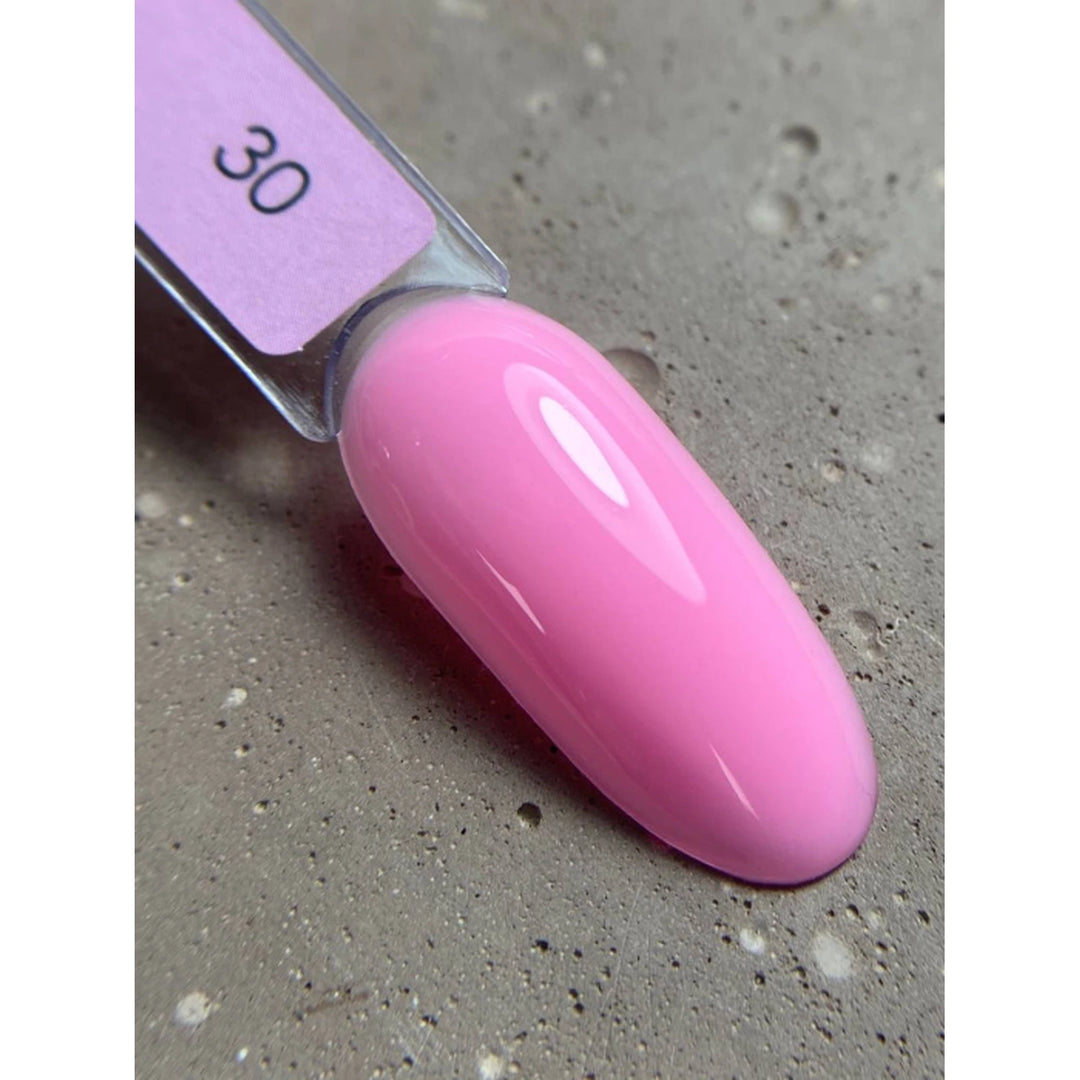 Swatch of glossy light pink UV gel nail polish on a display tip, labeled with number 30