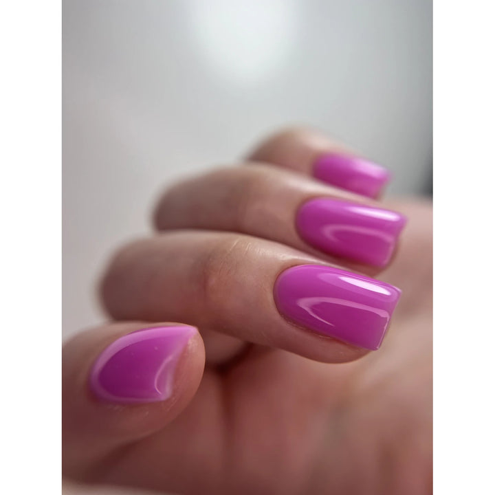 Hand with glossy pink gel manicure, square-shaped nails, professional nail polish