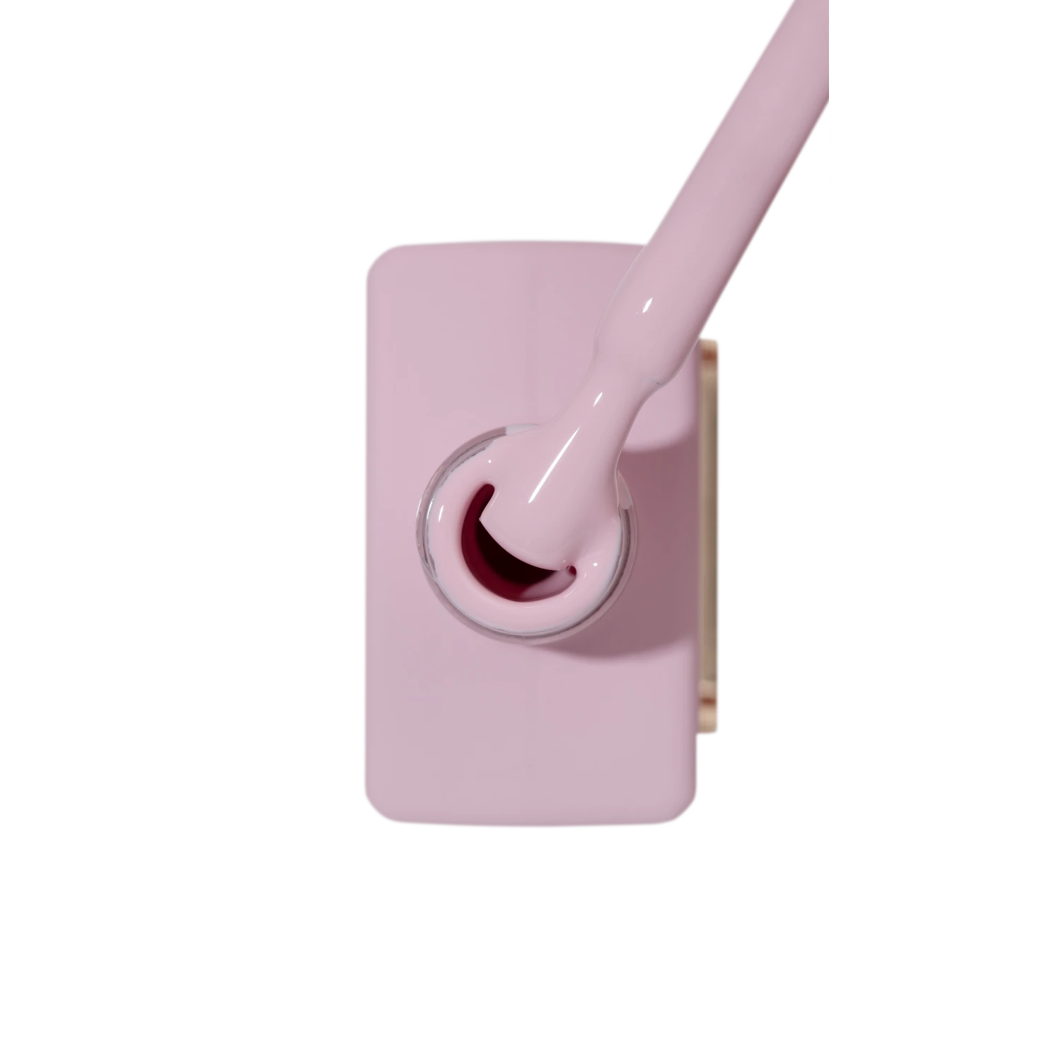 Light pink nail polish bottle with brush shown from above, ideal for manicures