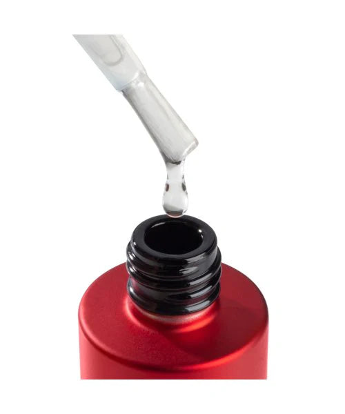Red container with a black cap being filled with clear liquid using a dropper.