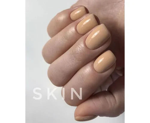 Hand with short, glossy nude beige gel polished nails, natural manicure close-up