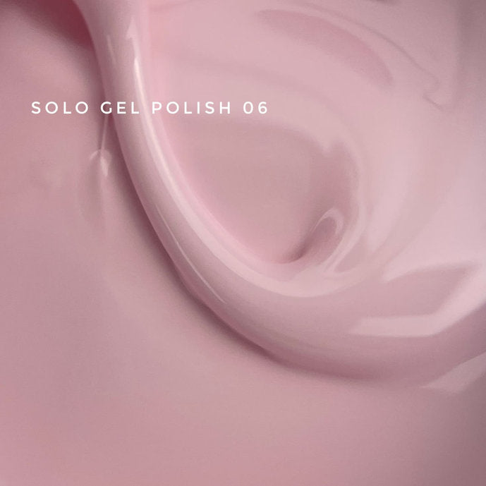 Close-up of creamy light pink gel polish, labeled Solo Gel Polish 06, for manicures.