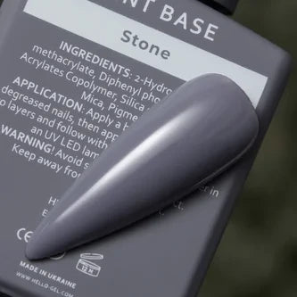 Gray gel nail polish swatch labeled Stone, displayed on product ingredient label background.