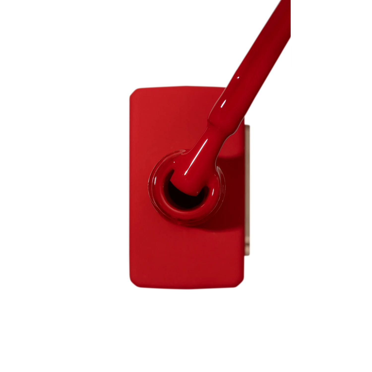 Red gel nail polish bottle with applicator brush for manicure and pedicure