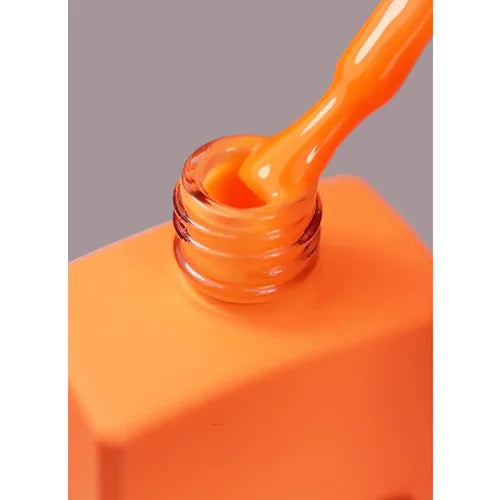 Bright orange gel nail polish bottle with brush, manicure supplies