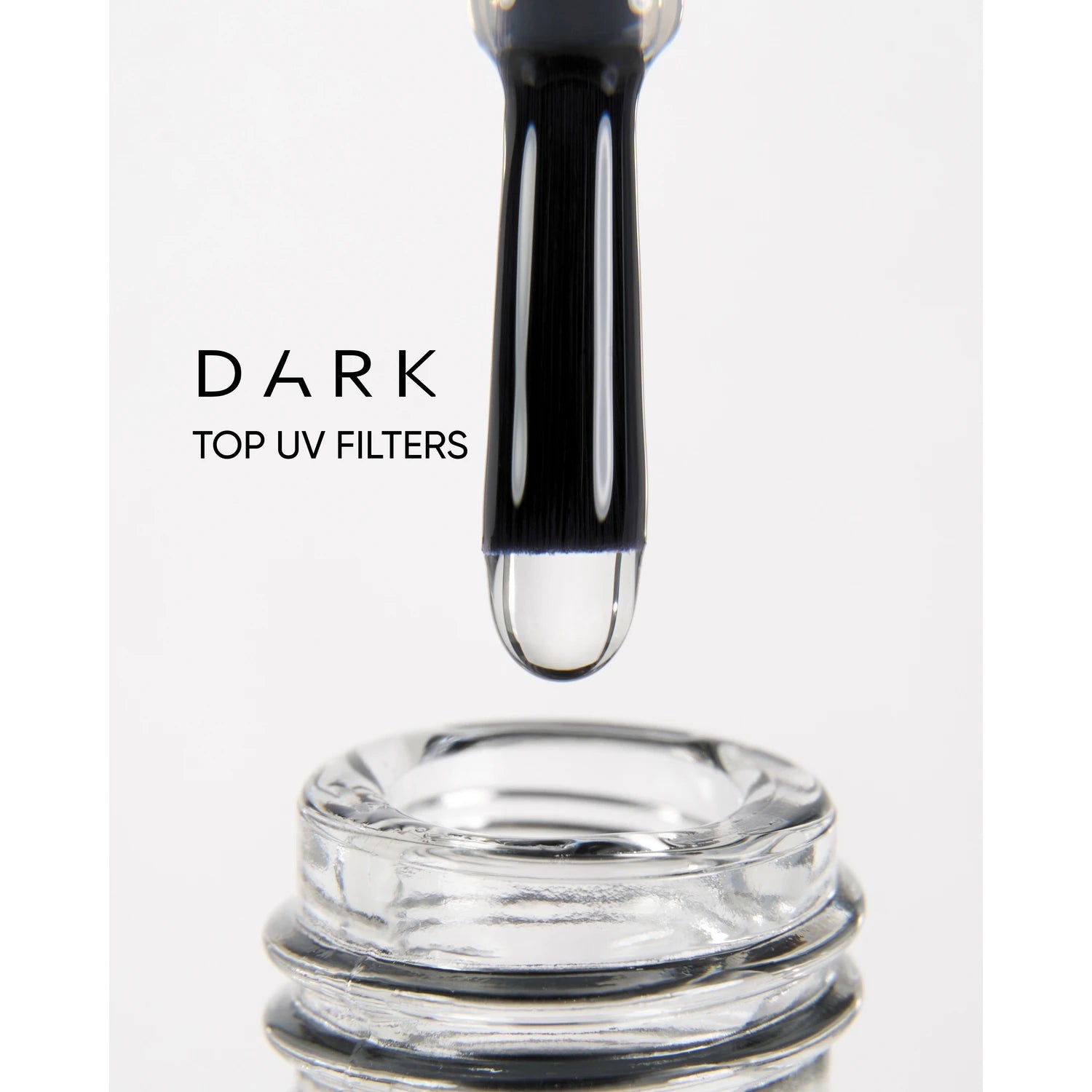 Nail polish brush with clear gel above open bottle, labeled dark top UV filters