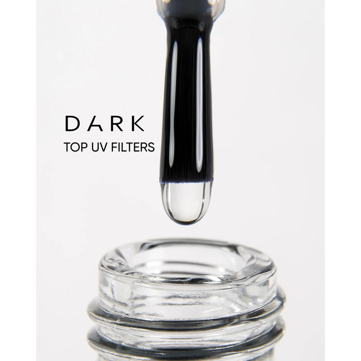 Nail polish brush with clear gel above open bottle, labeled dark top UV filters