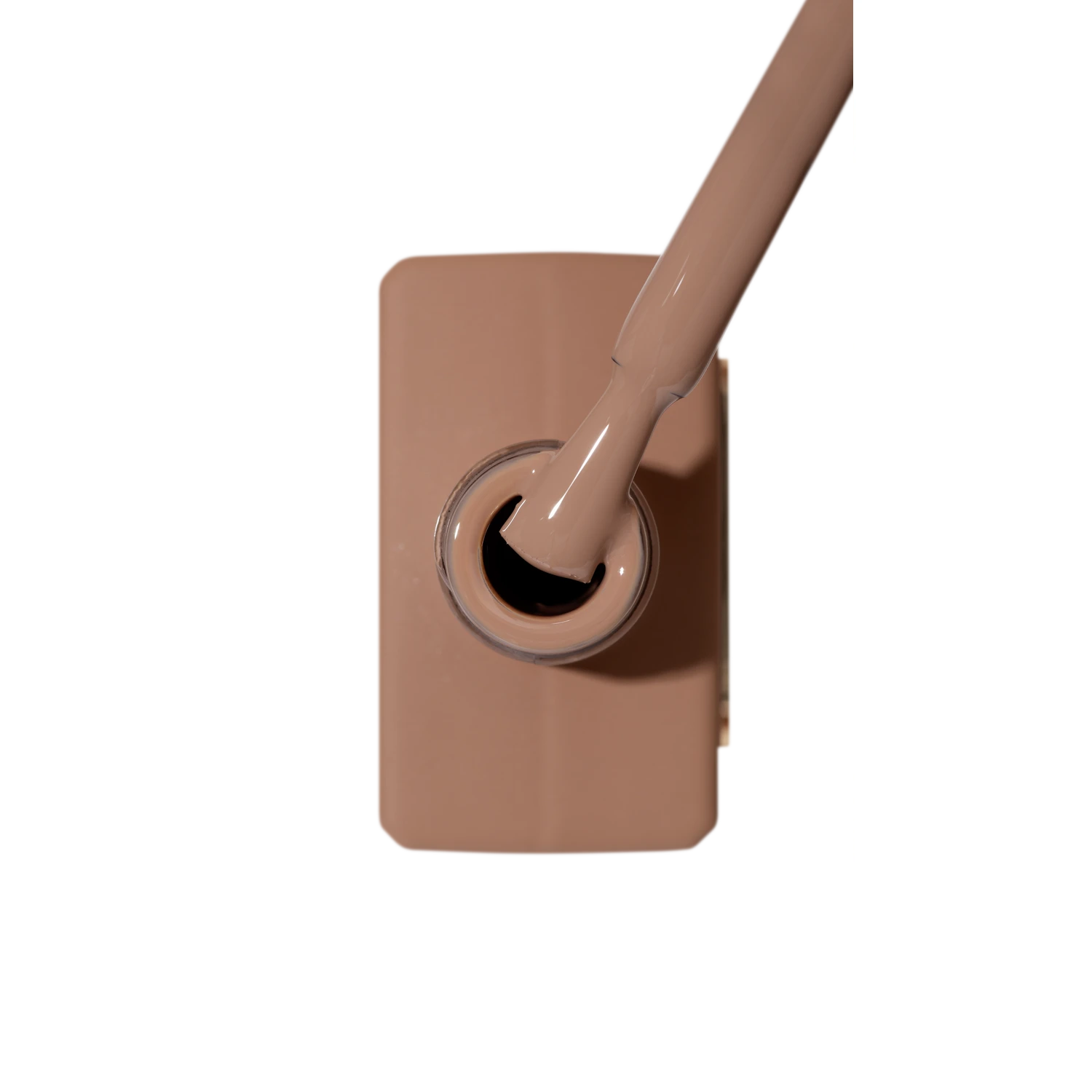 Open bottle of nude toffee gel nail polish with brush applicator, manicure product