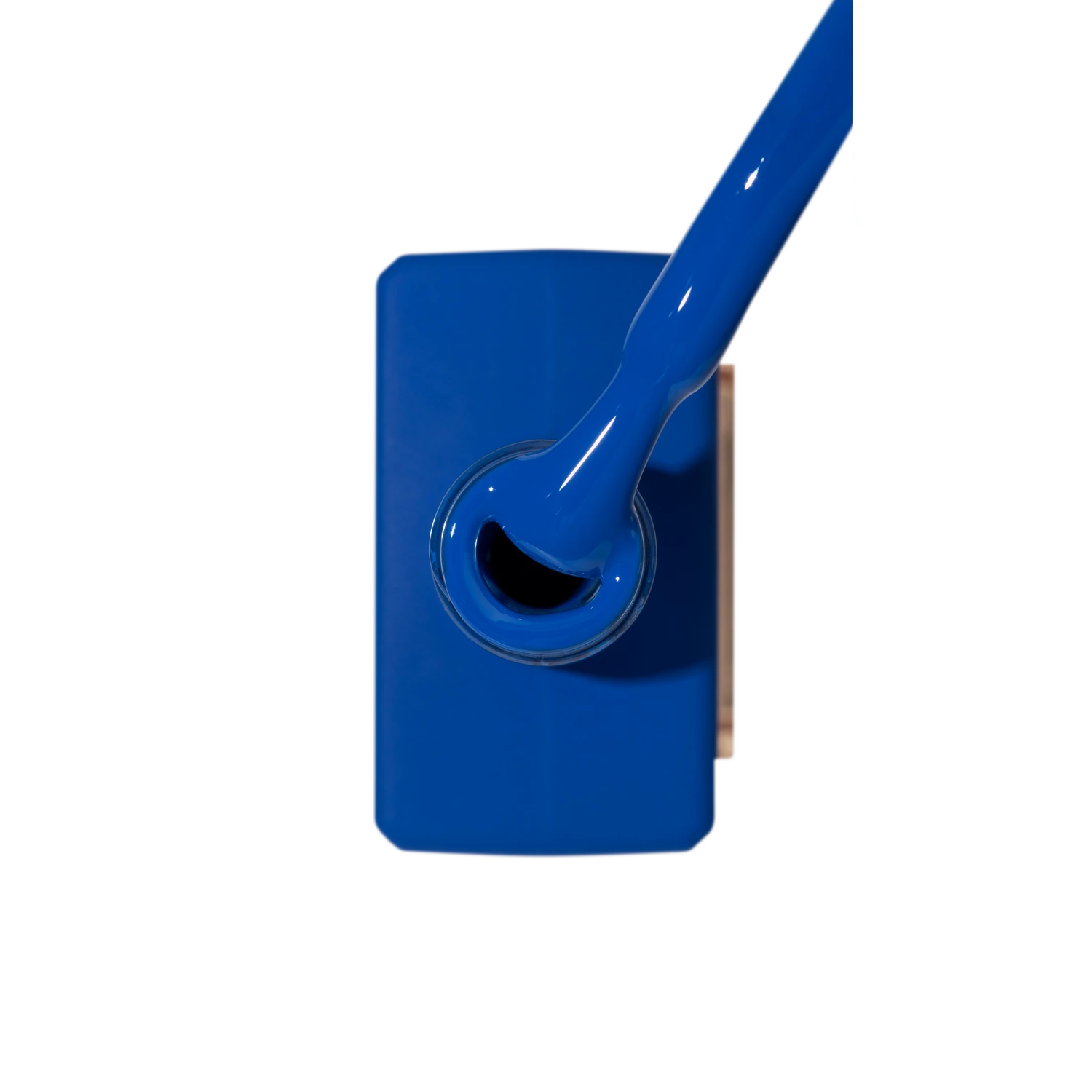 Vivid blue nail polish bottle with brush, professional manicure product