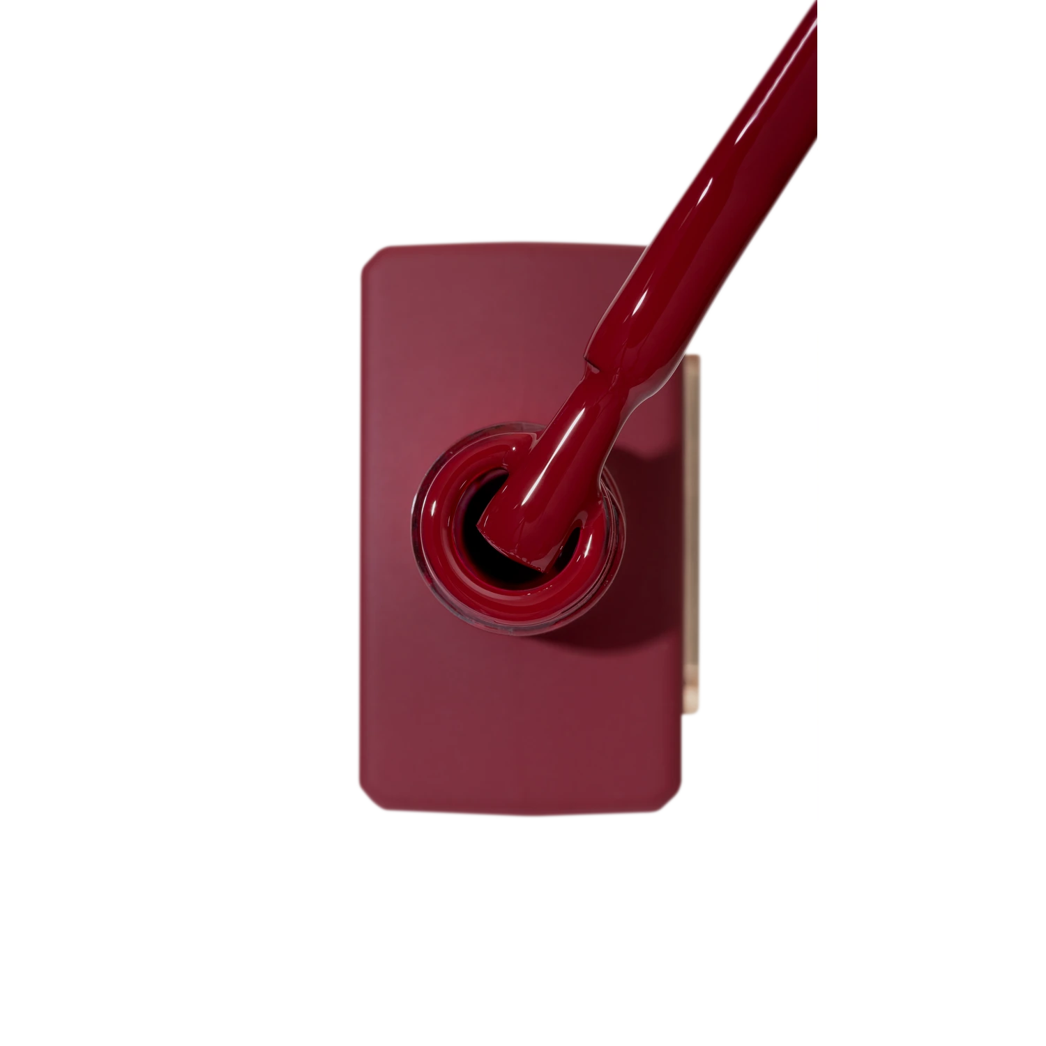 Deep red gel nail polish bottle with brush, professional manicure product