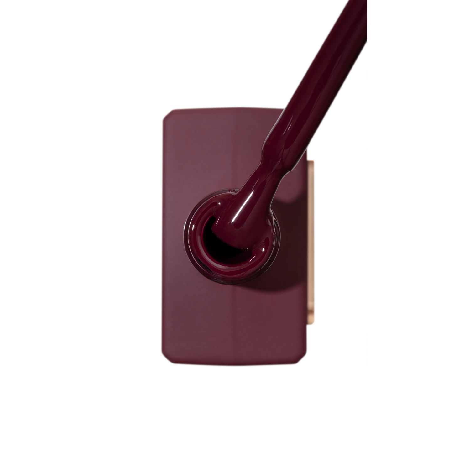Burgundy UV gel nail polish bottle with applicator brush, professional nail product