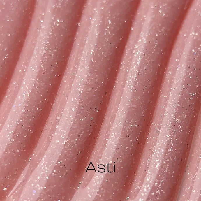 Close-up of shimmery pink UV gel nail product with a glittery texture