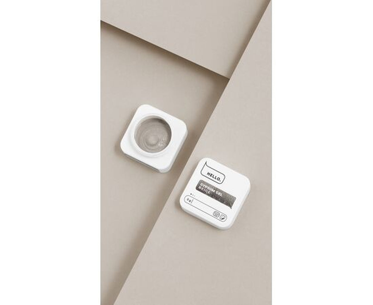 Beige nail gel in white square container for professional manicure use