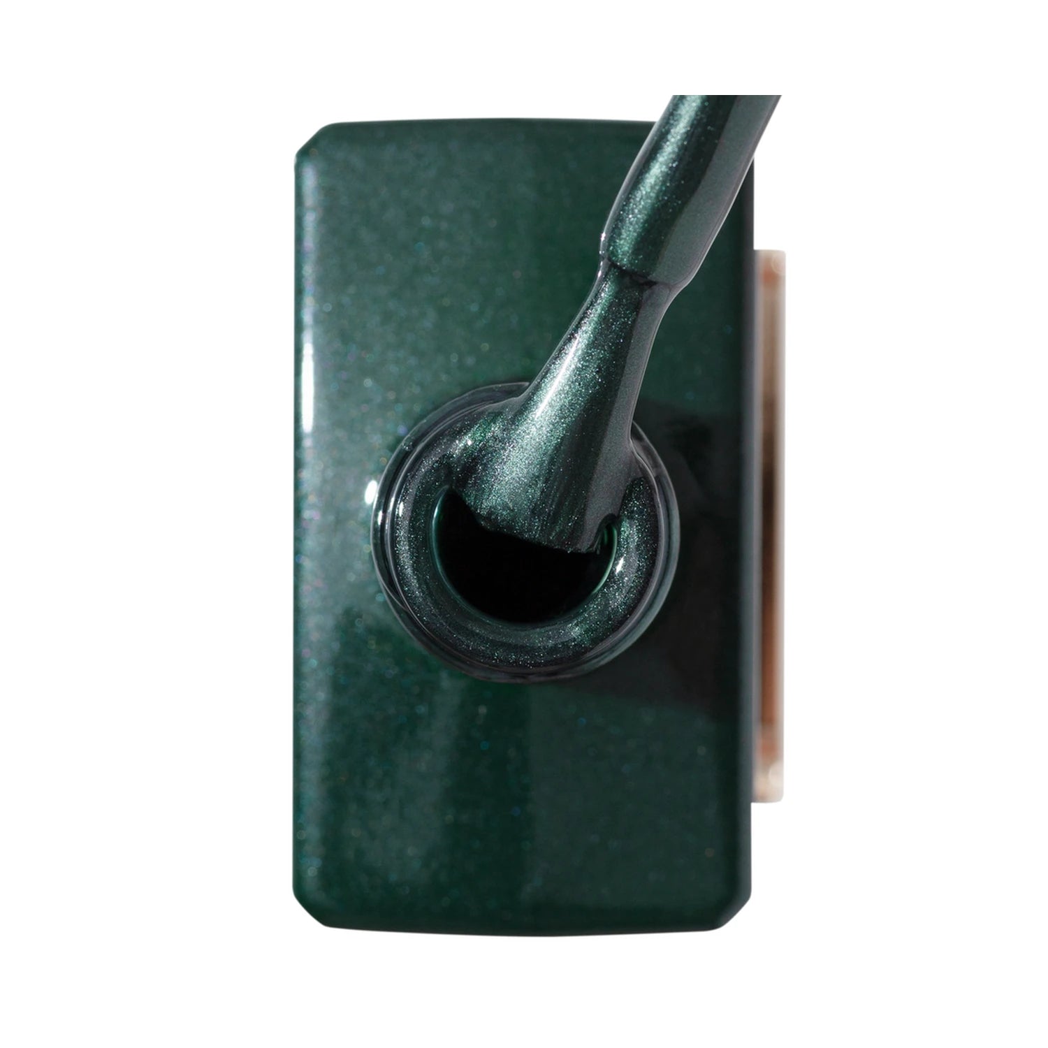 Close-up of a shimmery dark green nail polish bottle with applicator brush