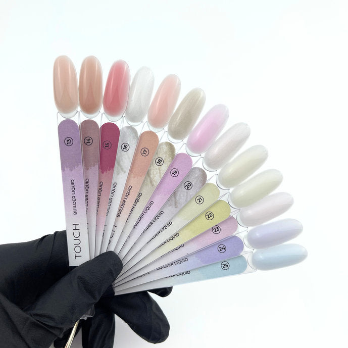 Hand holding fan of nail color swatches with pastel builder gel polish shades