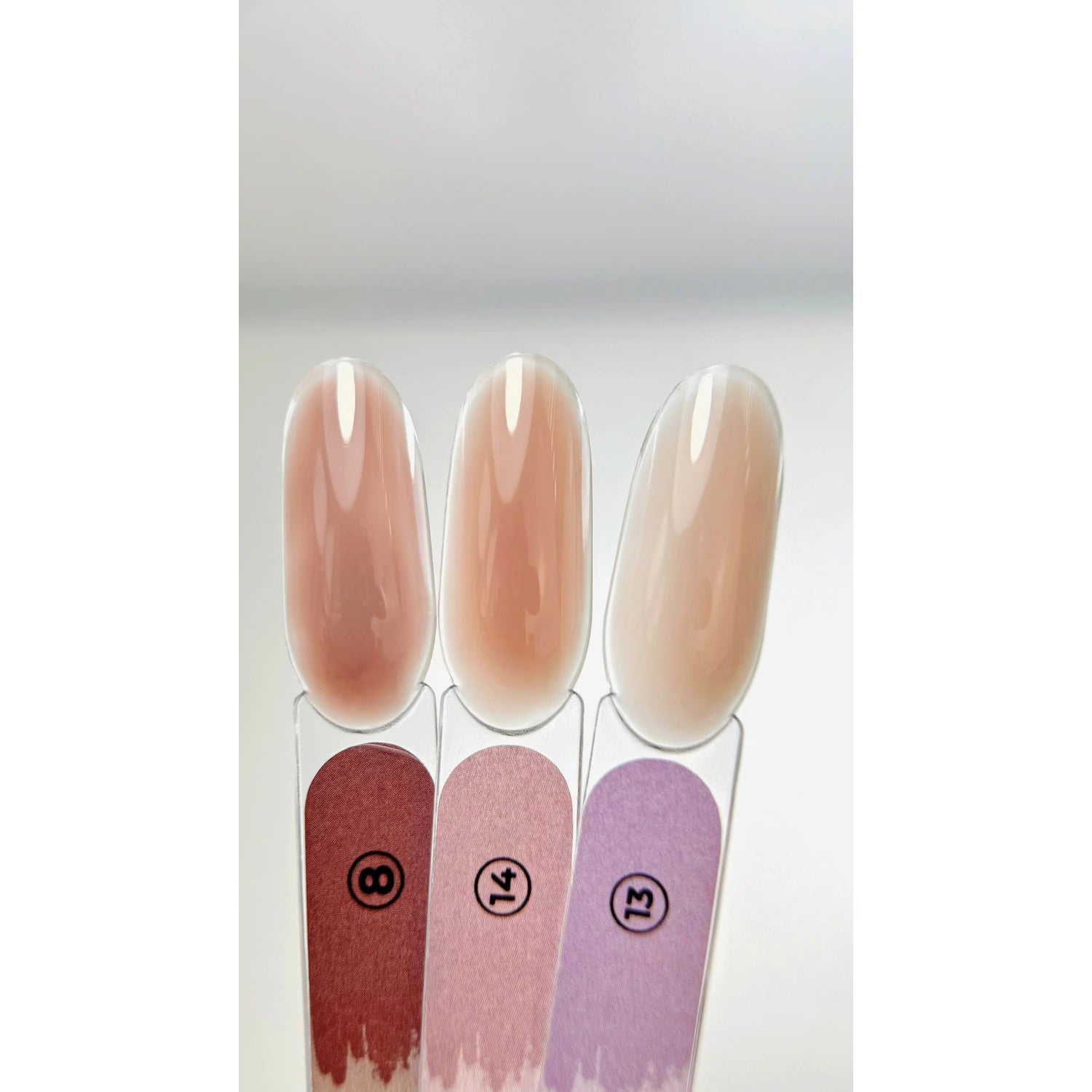 Three nail polish color swatches in nude pink shades, labeled 8, 14, 13