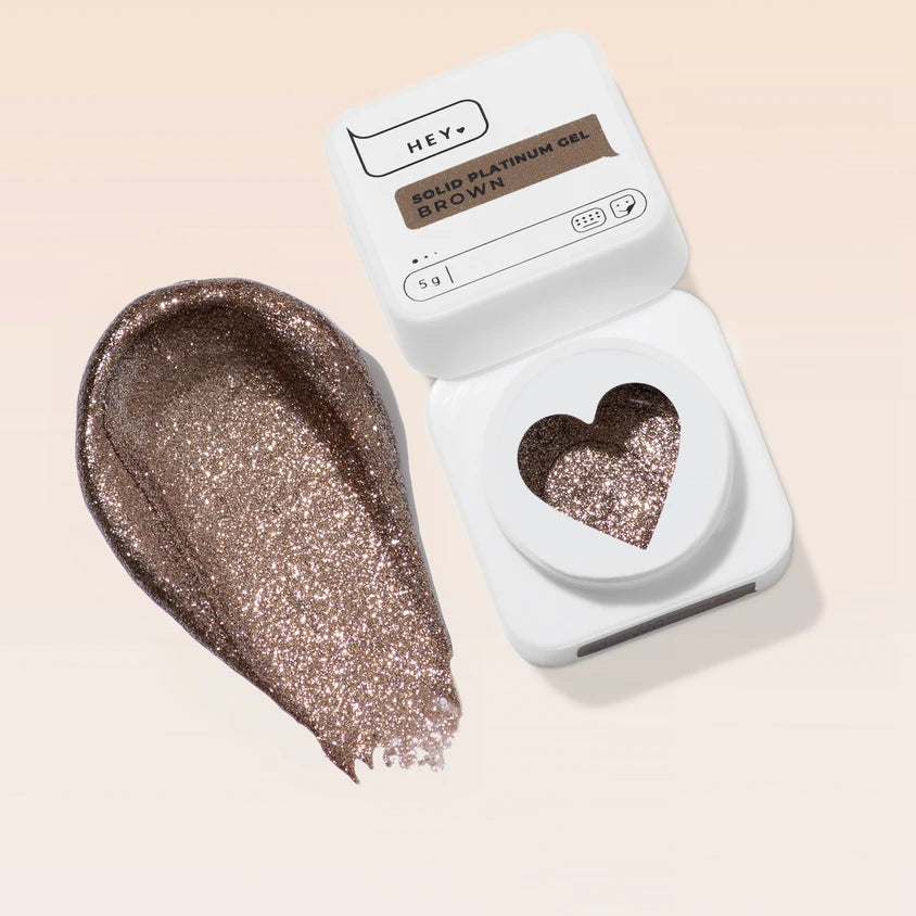 Brown glitter gel polish swatch with open white container for manicure and nail art