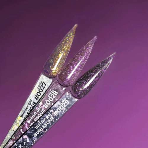 Three glittery nail art brushes with visible brand names on a purple background