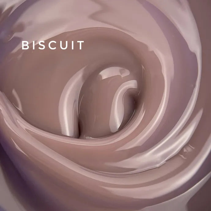 Close-up of nude beige nail gel polish with glossy, creamy texture and 'BISCUIT' text.