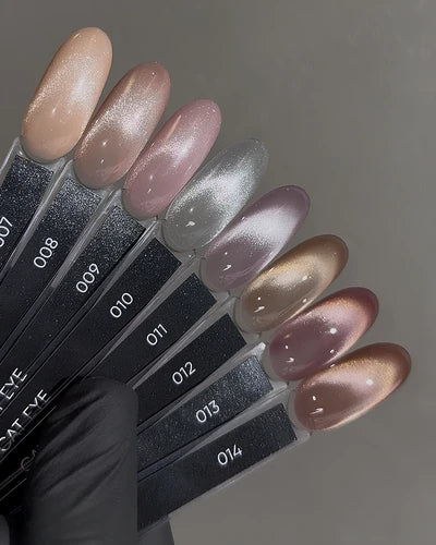Cat eye nail polish color palette with shimmering nude, pink, silver, and bronze swatches.