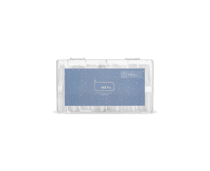 Clear acrylic coffin nail tips in a transparent storage case for nail art and manicures