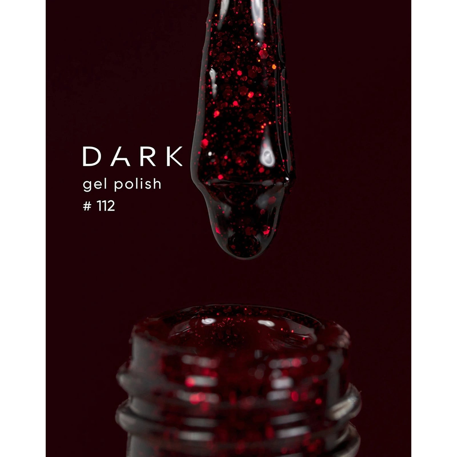 Dark glitter gel polish #112 with red shimmer on applicator over open bottle