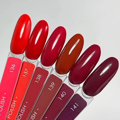 UV gel nail polish color swatches in red, burgundy, and plum shades on display sticks