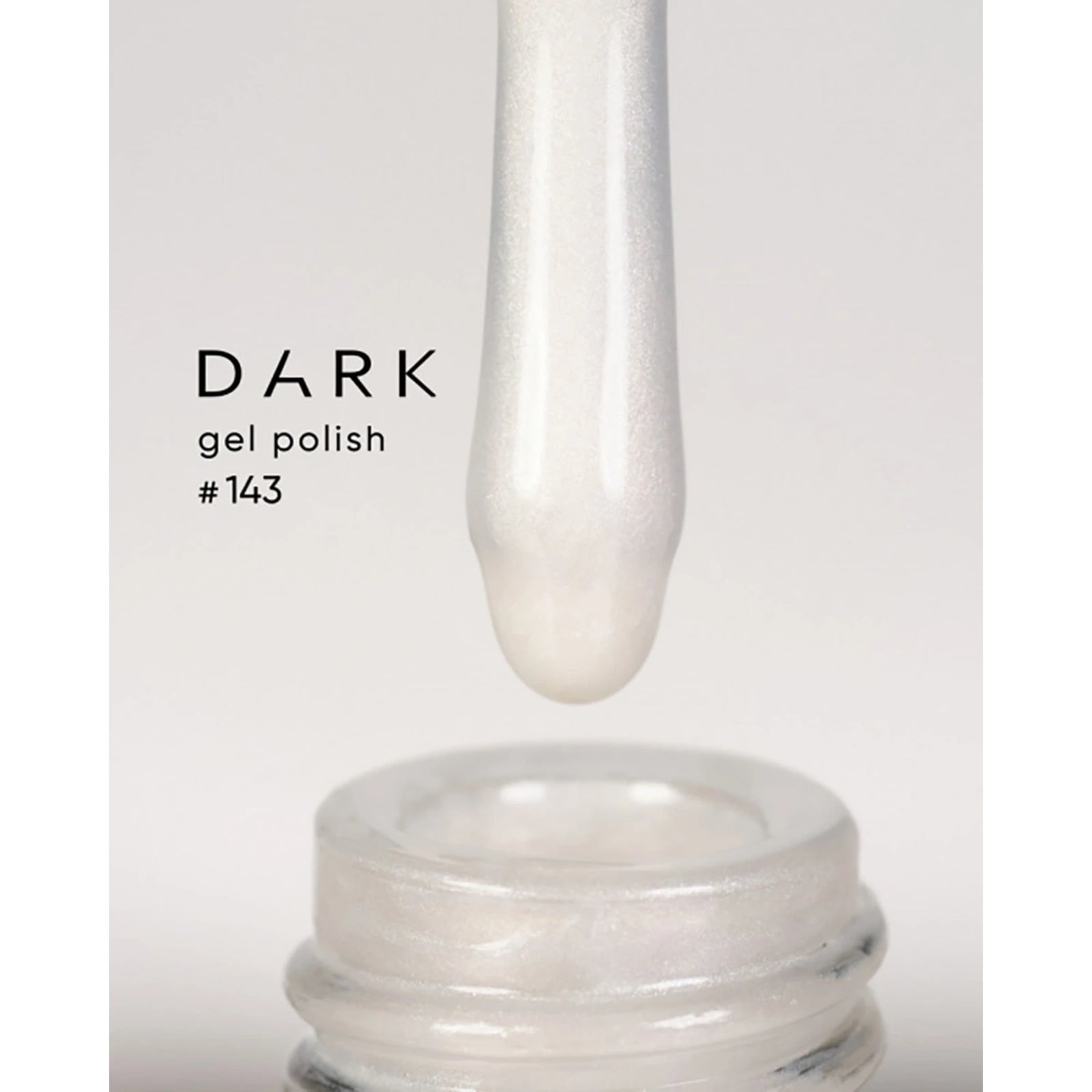 White shimmery gel nail polish on applicator above open bottle, labeled DARK gel polish #143