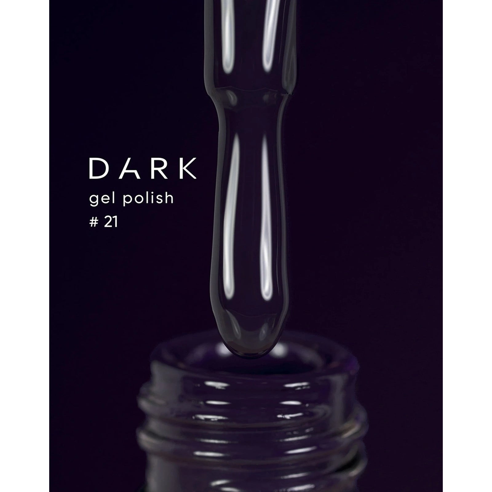 Dark gel polish #21 drop on brush above bottle for manicure and pedicure